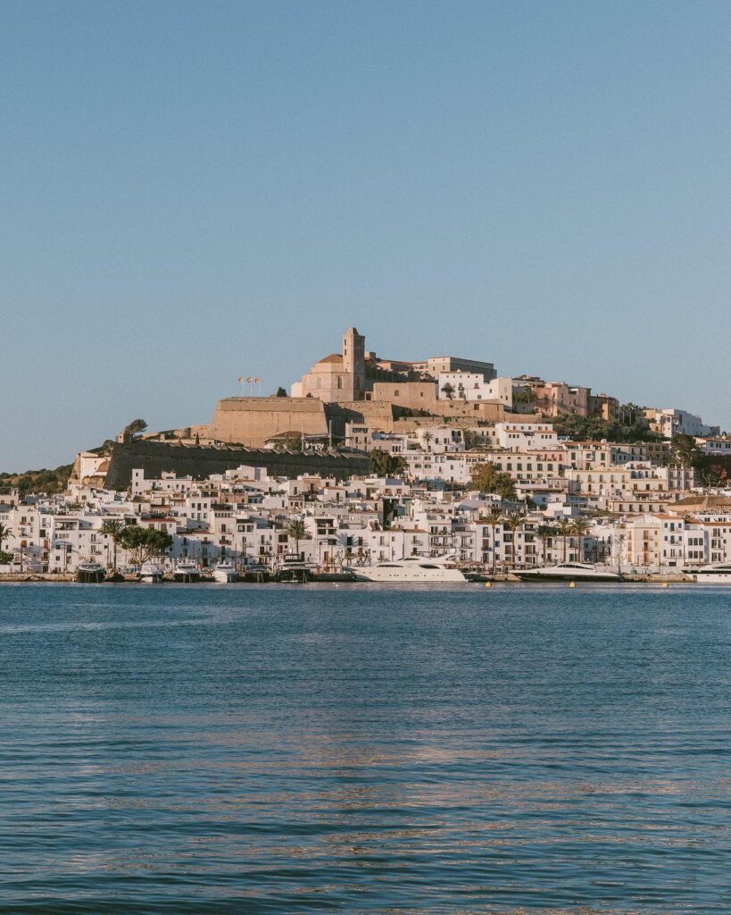 Beautiful shot of Ibiza town from the sea at sunset, offering a view of the coastline in Mallorca